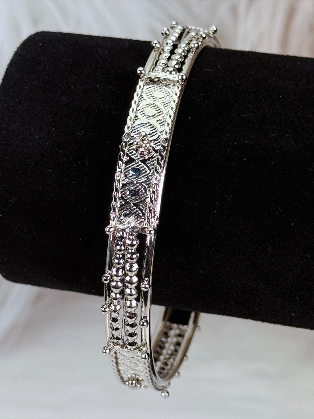 Elegant Silvertone Bangle Bracelet with Intricate Detailing